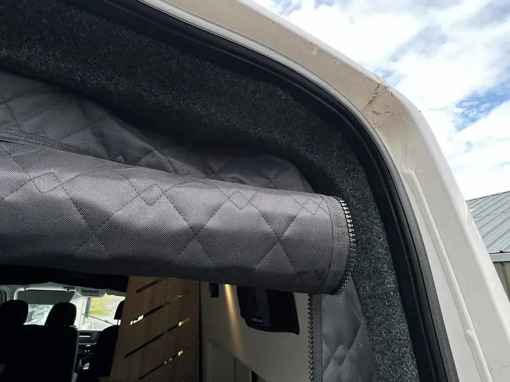 Detalhe da cortina blackout térmica preta para porta traseira de van, tecido acolchoado com acabamento em zíper