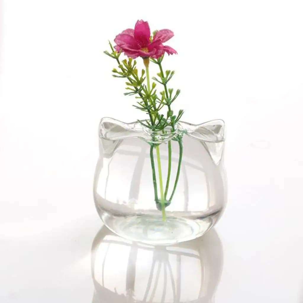 Vaso de vidro transparente em forma de gato com flor rosa