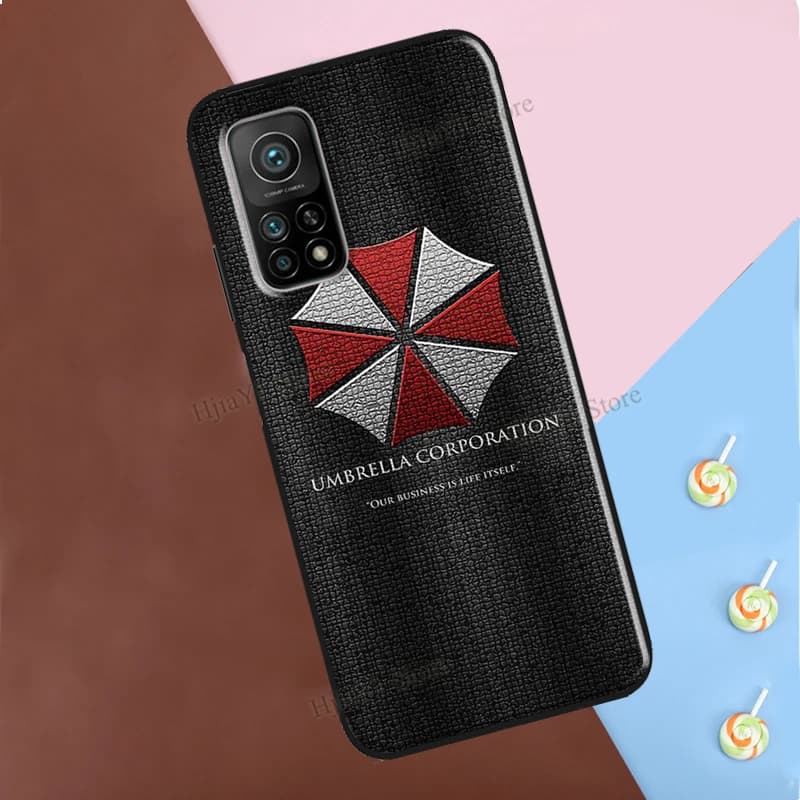 Capa preta texturizada para Xiaomi Poco com logo Umbrella Corporation vermelho e branco e frase Our Business Is Life Itself