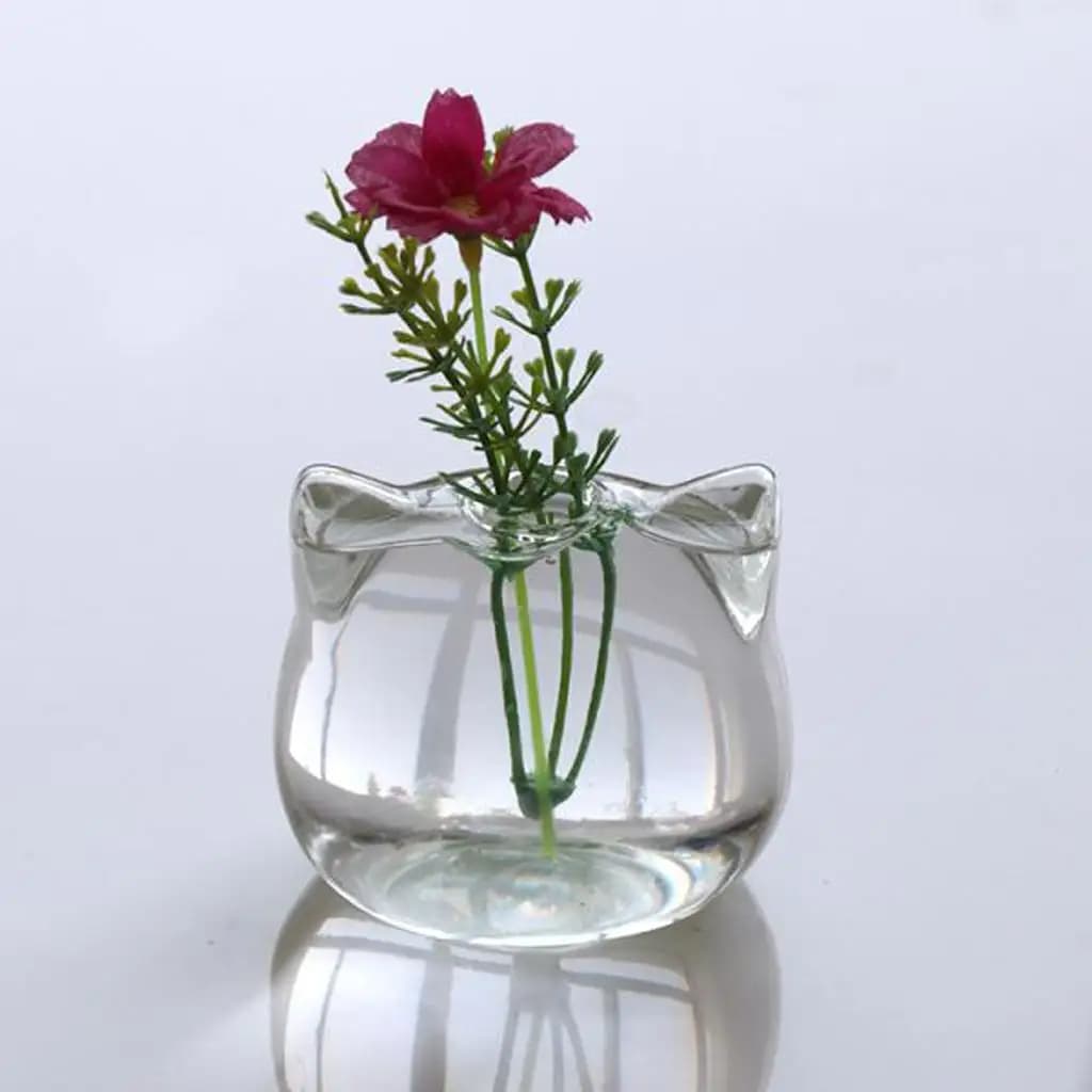 Vaso de vidro transparente em forma de gato com flor rosa