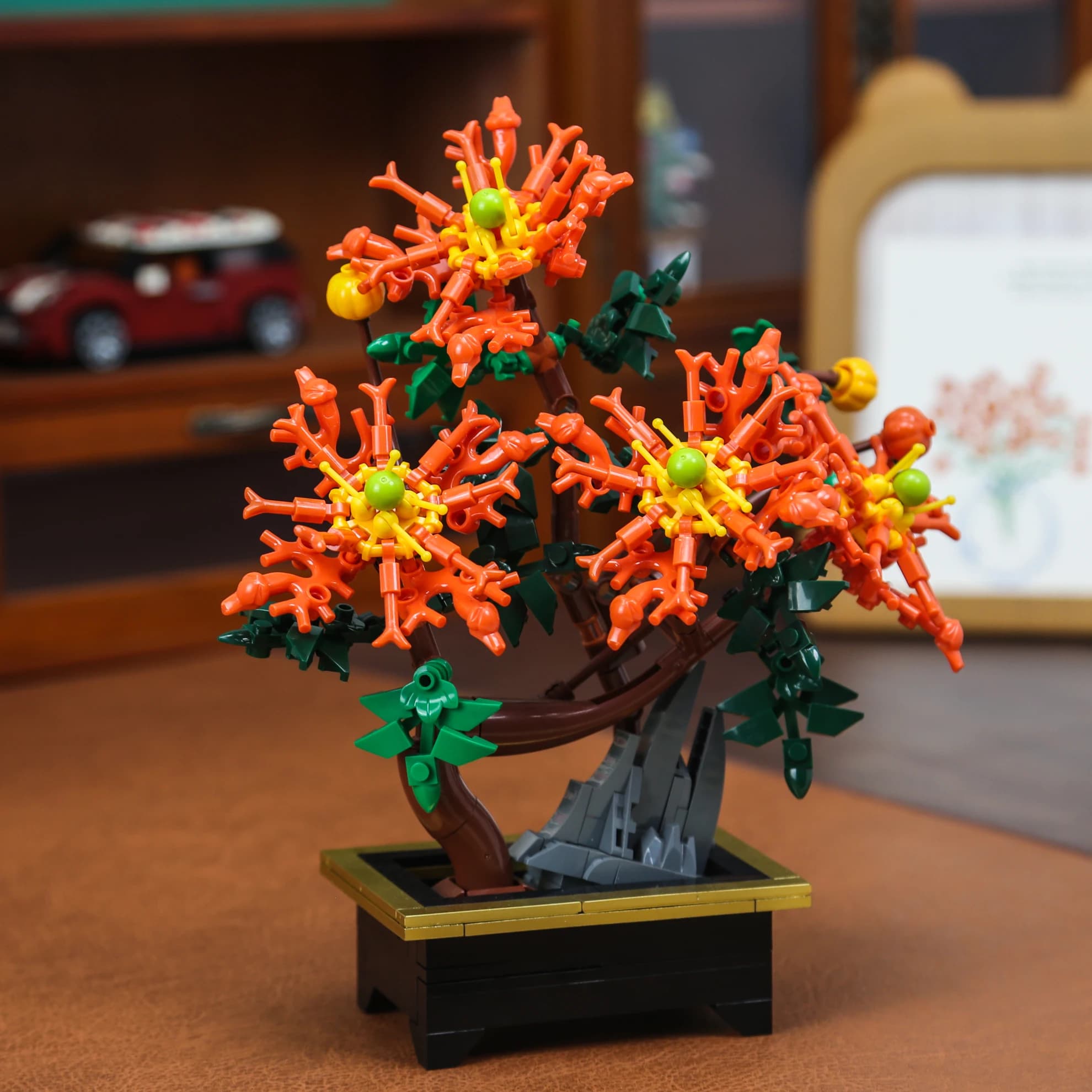 Brinquedo decorativo de bonsai crisântemo com flores laranja e base preta para crianças