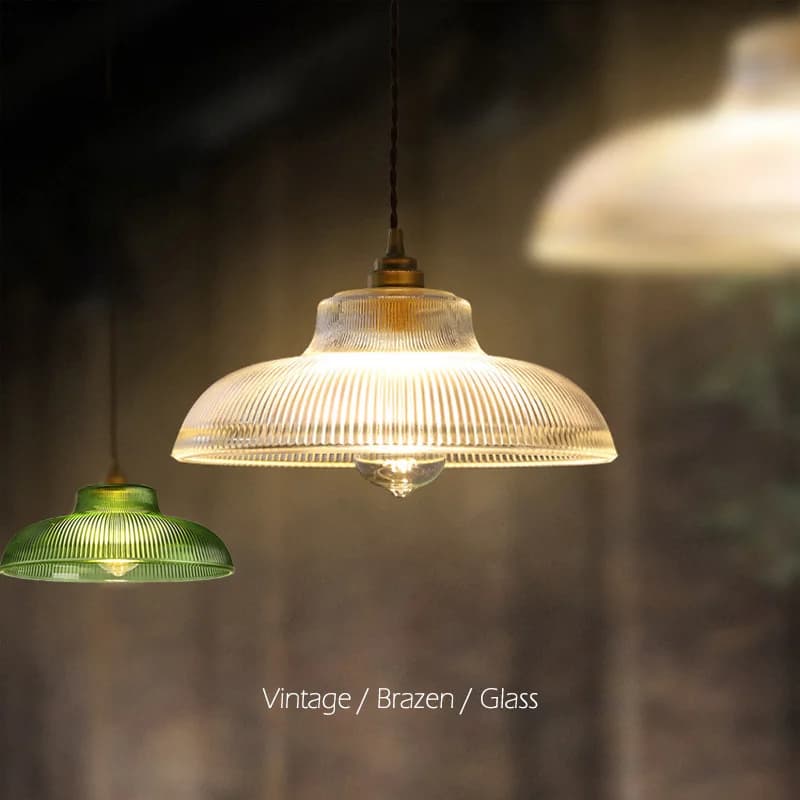 Luminária pendente de vidro verde estilo vintage com cúpula transparente, iluminada, fundo escuro.