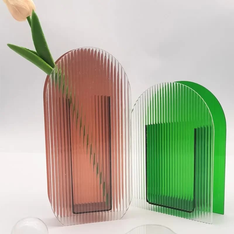 Vasos de acrílico coloridos com plantas e flores dentro