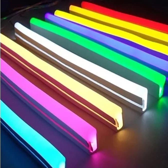 Fitas neon LED coloridas de 12V, flexíveis e siliconadas, dispostas em uma superfície escura