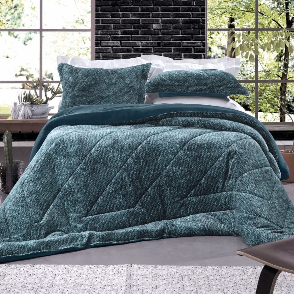 Edredom azul marinho plush em cama de casal com almofadas verdes