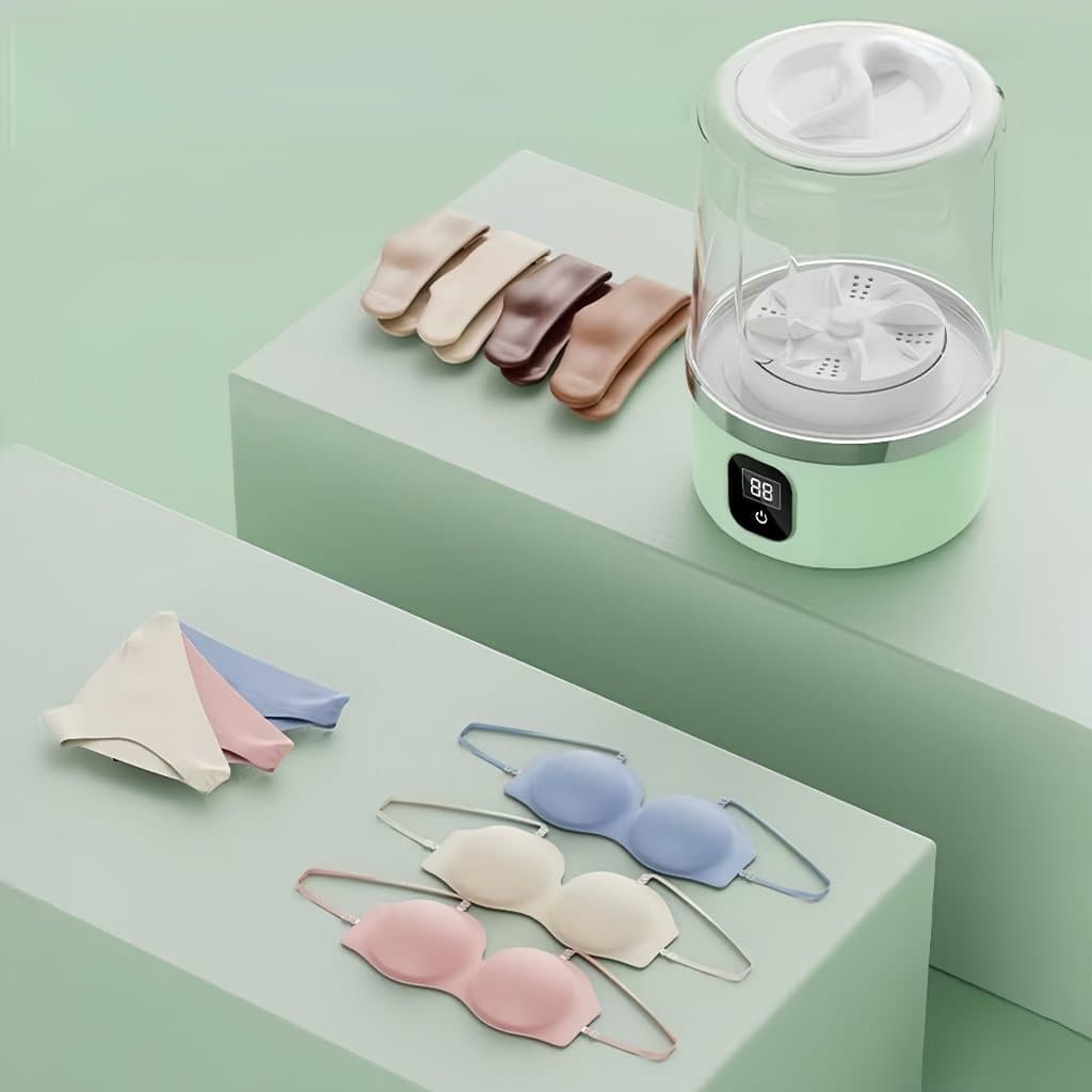 Mini máquina de lavar roupas íntimas e meias com peças penduradas, display digital e fundo verde