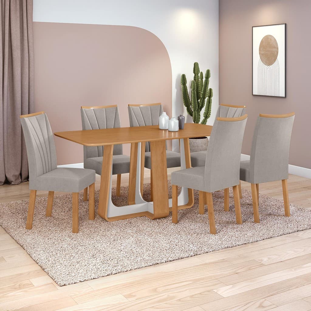 Conjunto de mesa de jantar com seis cadeiras de veludo cinza e base de espelho, sobre um tapete, em um ambiente com parede rosa e cinza.