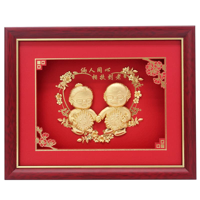 Quadro decorativo dourado com figuras de bebê em comemoração de aniversário de casamento