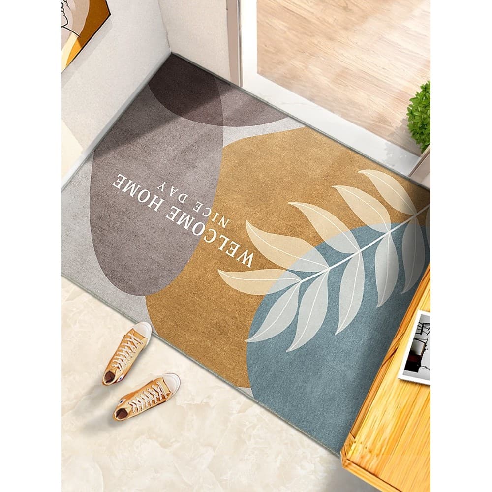 Tapete de entrada antiderrapante com design de folhas e texto 'WELCOME HOME' em branco