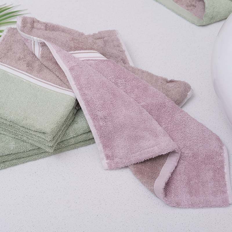 Toalhas de banho de fibra de bambu rosa, verde e bege empilhadas