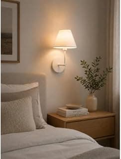 Luminária de parede branca com cúpula injetada em um quarto minimalista.