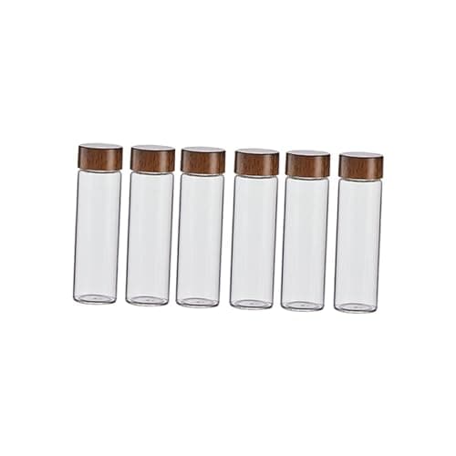 Seis tubos de vidro transparente com tampas de madeira para armazenamento de grãos de café.