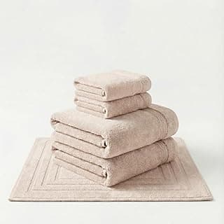 Conjunto de 5 toalhas de banho gigantes em bambu natural, cor bege, sobre uma toalha de piso.