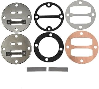 Conjunto de juntas metálicas para compressor de ar, incluindo discos prateados, pretos e bronze, e pedaços cinzentos, sobre fundo branco.