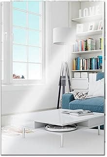 Sala de estar com sofá azul e mesa de centro branca, estante com livros e prateleira com a palavra 'LOVE'.