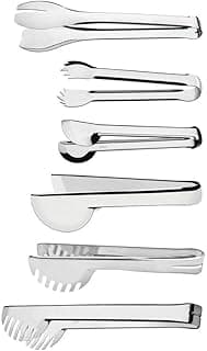 Sete utensílios de cozinha em aço inoxidável Tramontina Utility, incluindo pinças e espátulas, dispostos em uma linha contra um fundo branco.