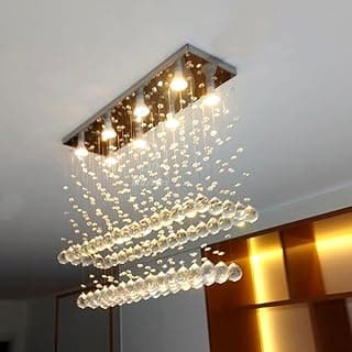 Luminária pendente de cristal acrílico com base inox, iluminando sala de jantar