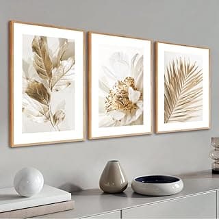 Kit de 3 quadros decorativos com folhagem dourada e molduras de madeira para decoração de parede moderna.