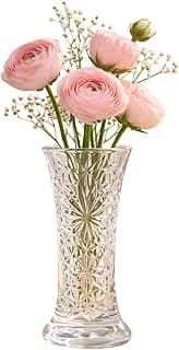 Vaso decorativo de vidro transparente com padrão geométrico contendo flores rosa