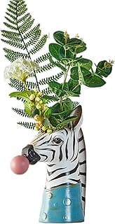 Vaso decorativo de cabeça de zebra com plantas verdes e flores brancas
