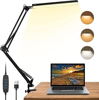 Luminária de mesa preta com braço giratório e três configurações de luz ao lado de um laptop.