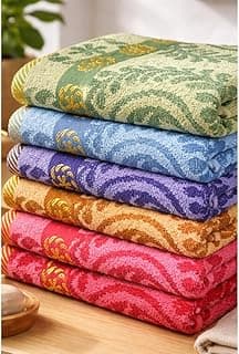 Toalhas de banho estampadas multicoloridas empilhadas sobre uma superfície de madeira