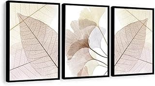 Quadros decorativos com folhas rosa e bege, molduras pretas, fundo branco.